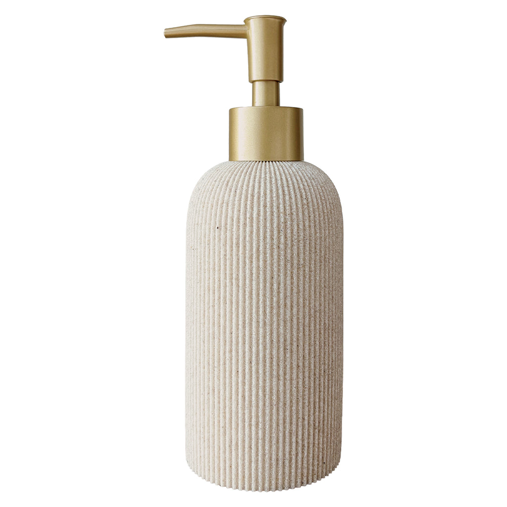A ribbed ceramic soap dispenser bottle in a warm cream-beige color, featuring a brushed gold pump dispenser on a solid white background.